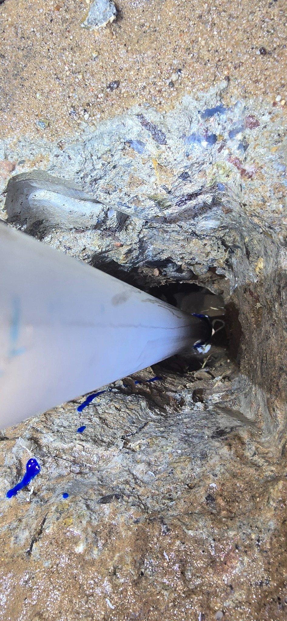 Exposed underground water service before repair